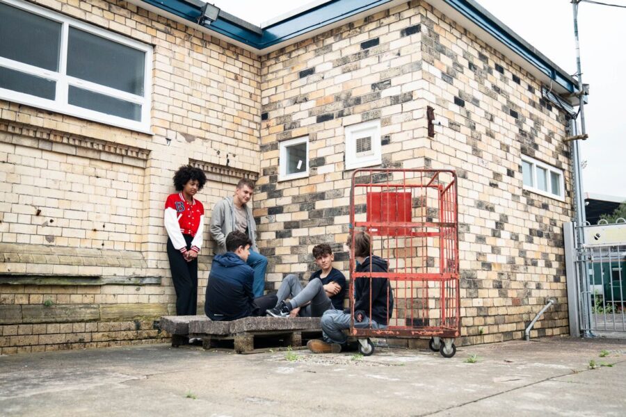 Group of teenagers gathered at a train station