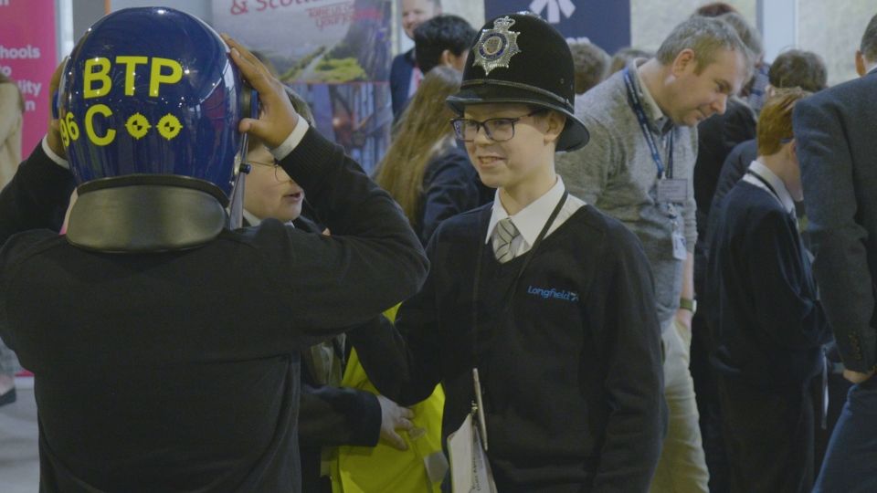 Students trying on BTP uniforms